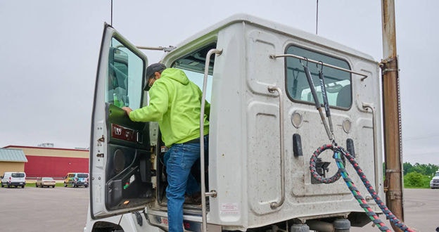 Driver entering truck cab
