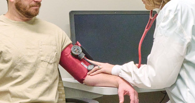 driver in medical examination getting blood pressure checked