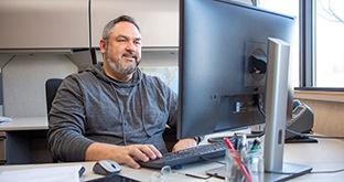 fleet manager at desk working at computer