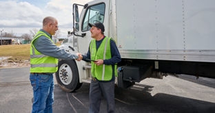 Driver Manager shake hands by box truck