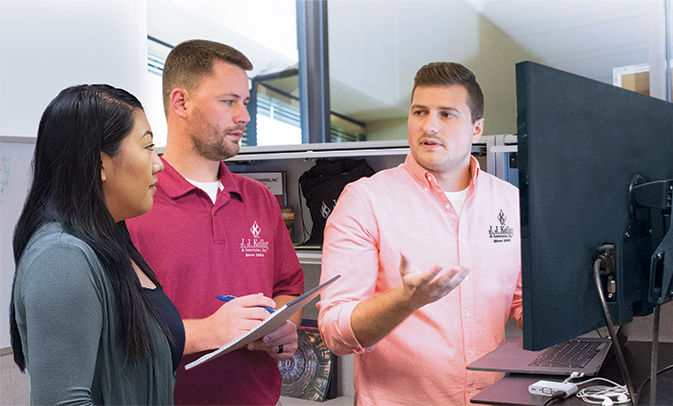 Three people collaborating at desk
