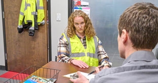 Driver and manager talking at desk