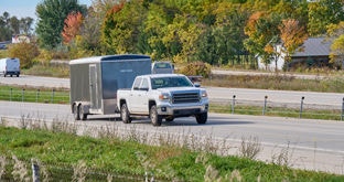Pickup Truck with enclosed trailer on freeway